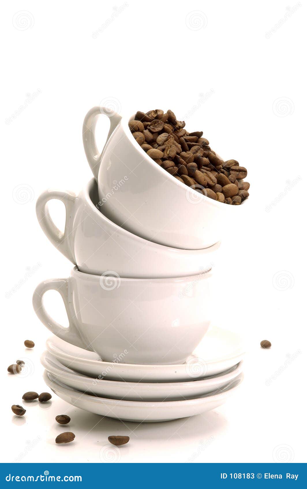 Coffee Beans and Cups. White coffee cups stacked with whole coffe beans.