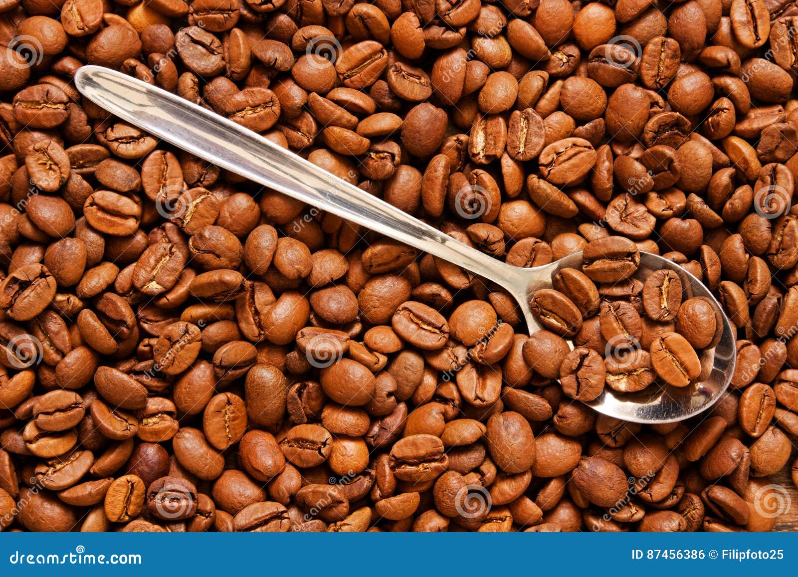 Coffee beans on a spoon stock photo. Image of caffeine 87456386