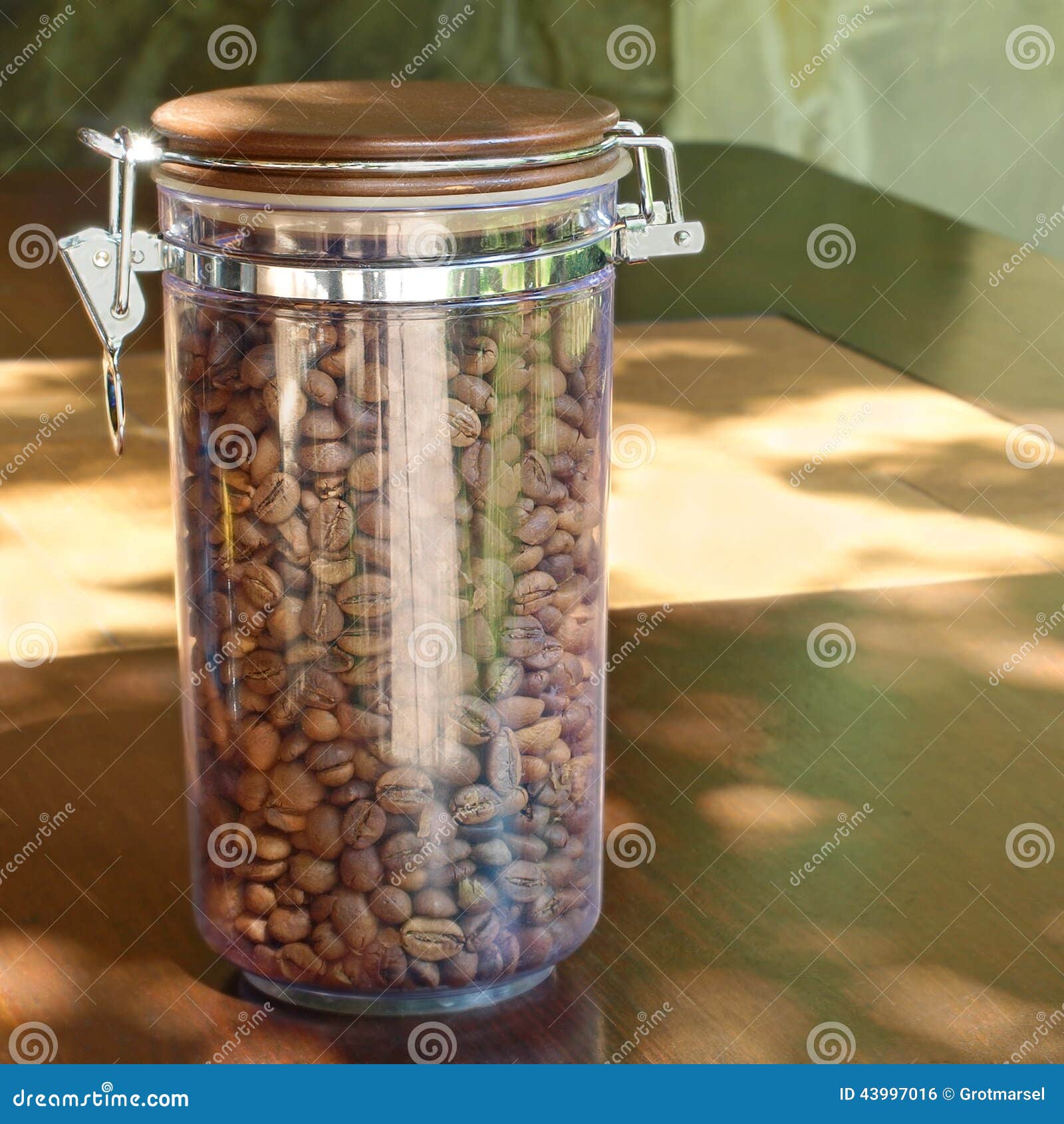Coffee Beans In Transparent Glass Container On Wooden ...