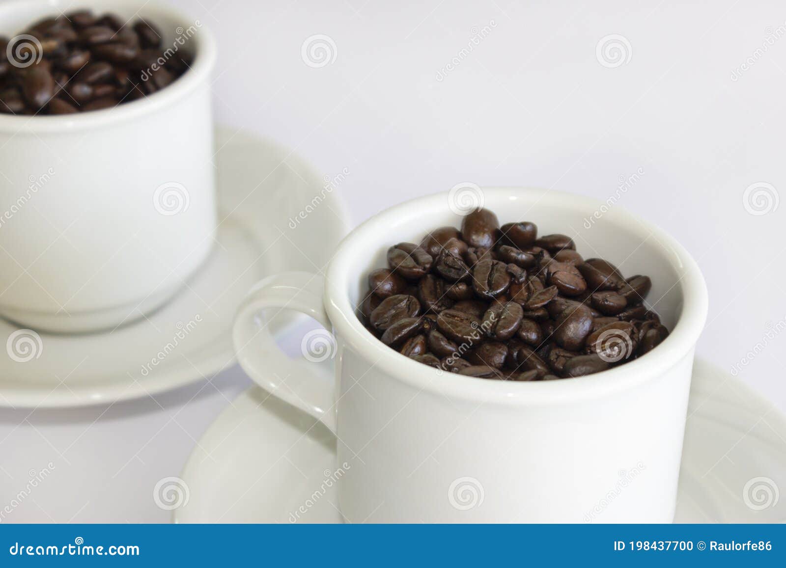 Coffee Beans in Two Coffee Cups , on White Isolated Background.Closeup