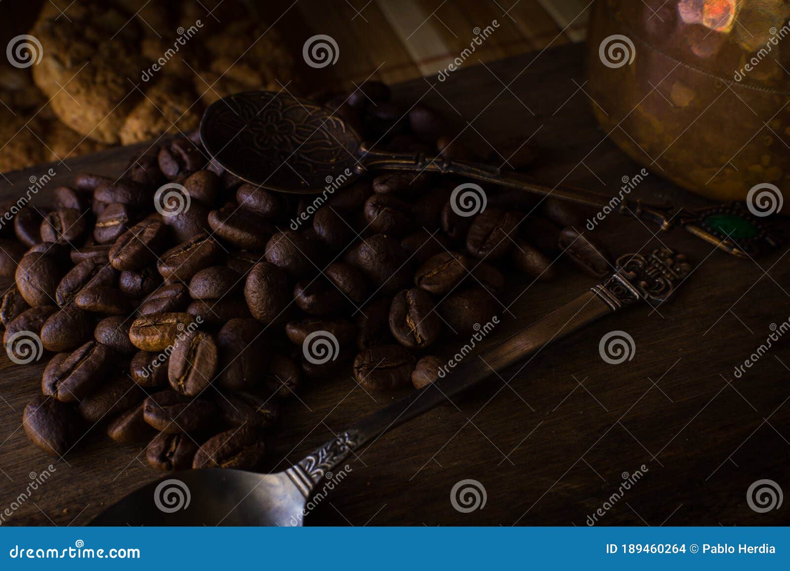 coffee beans on wood with spoons and cookies