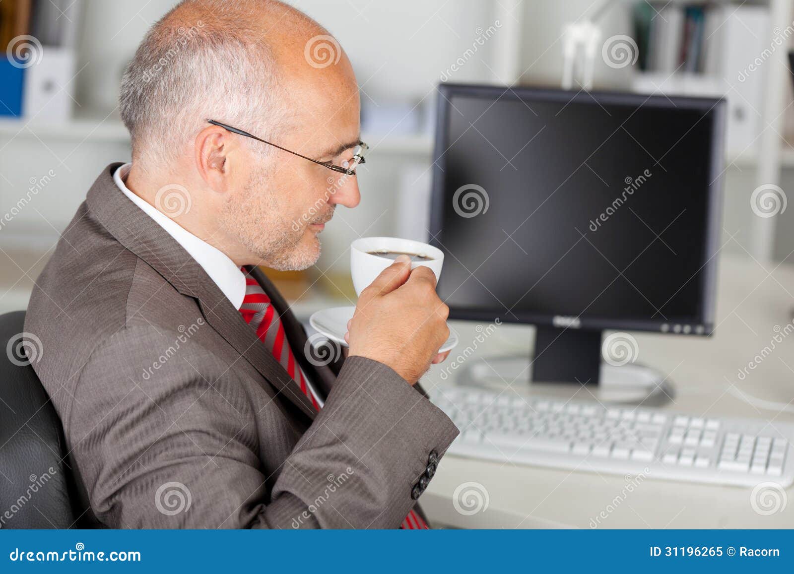 Businessman having a coffee break in the office
