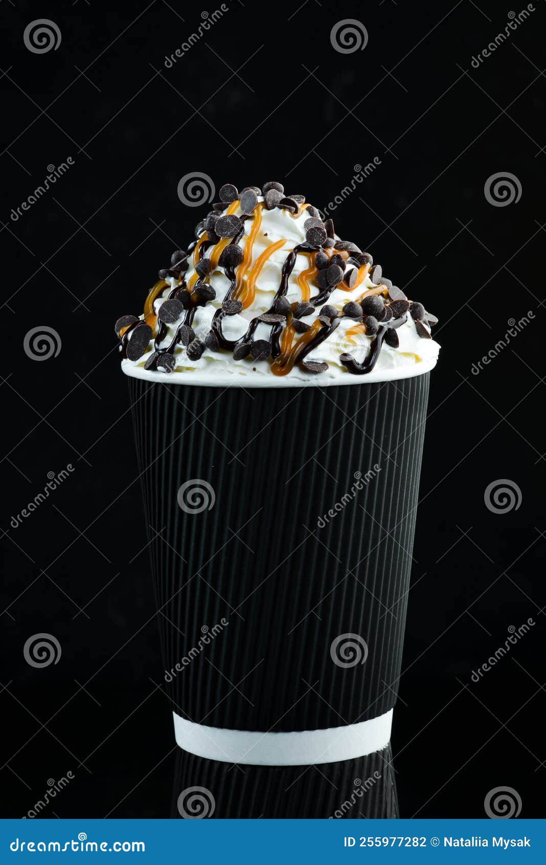 Coffee with Caramel and Cream in a Paper Cup. on a Black Background