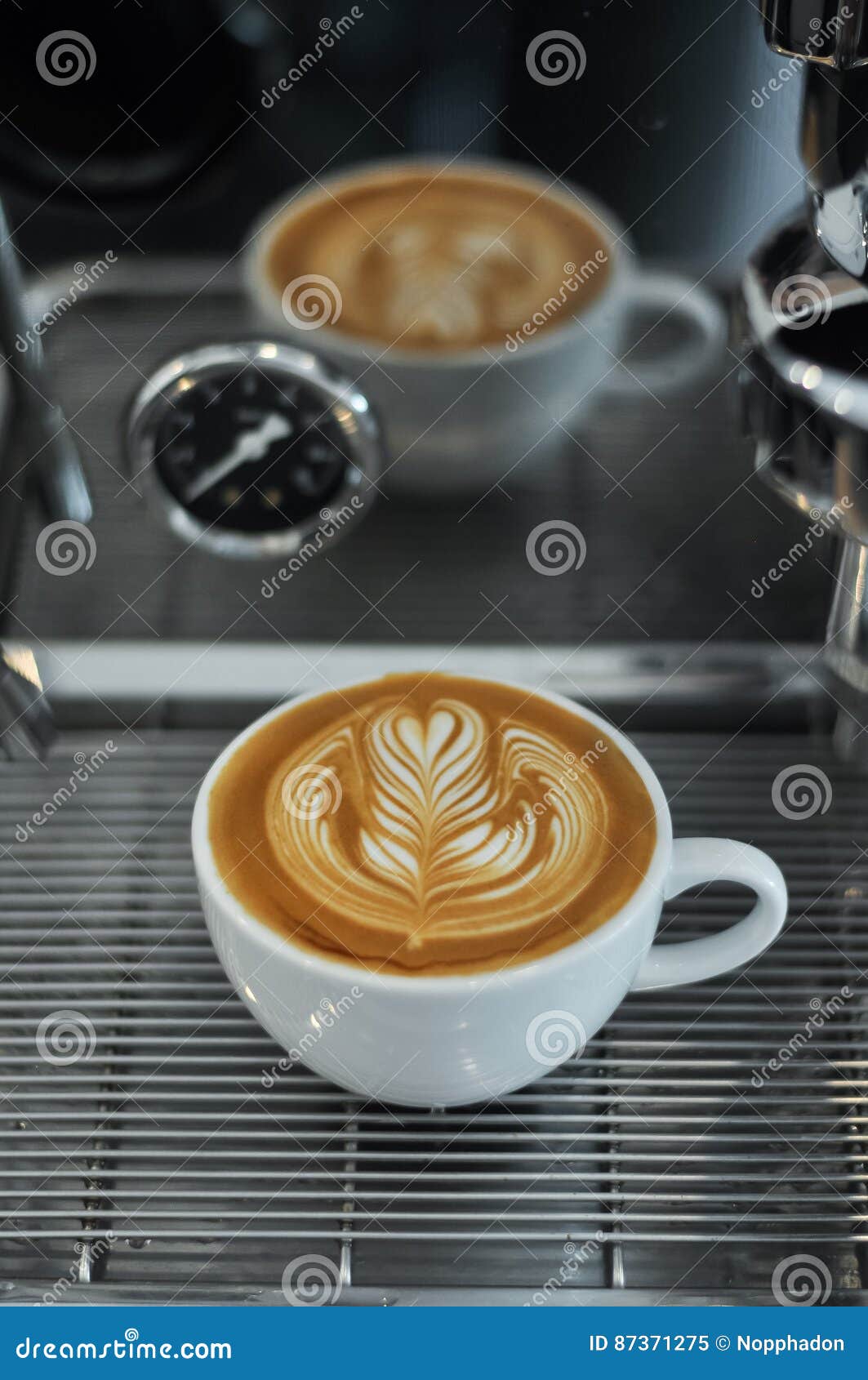 Coffee Cup with Latte Art on the Espresso Machine Tray Stock Image