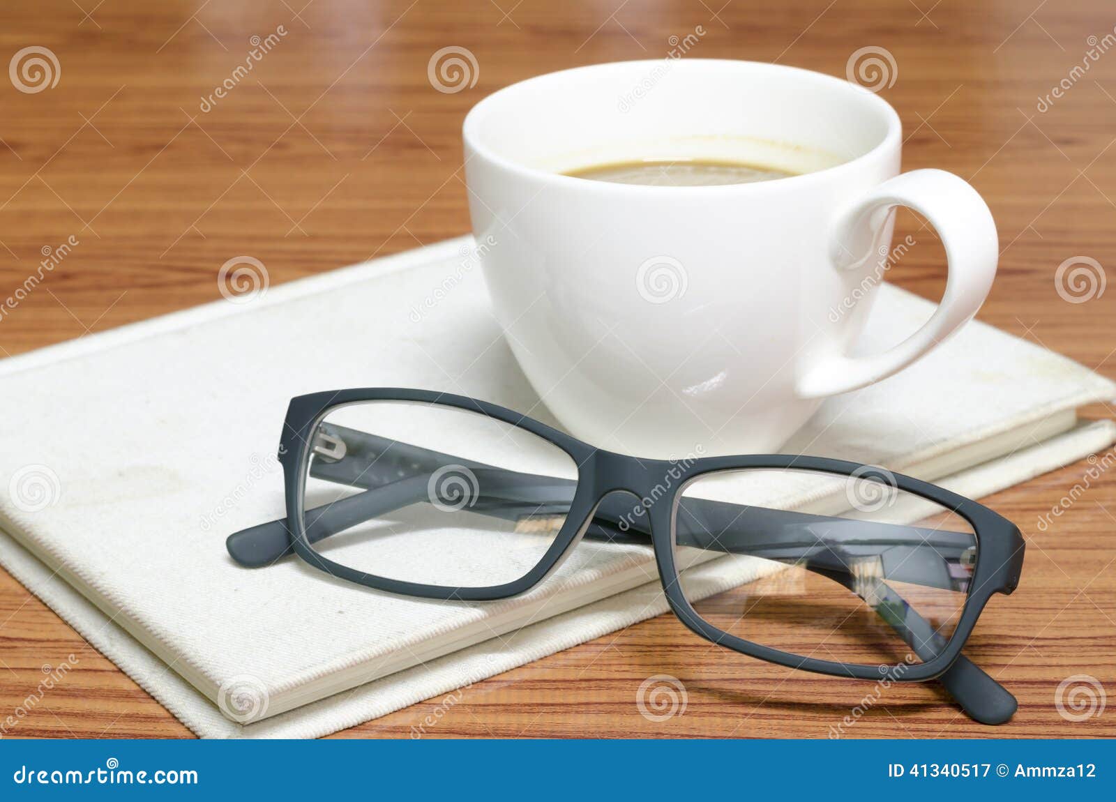 coffee cup and notebook with glasses