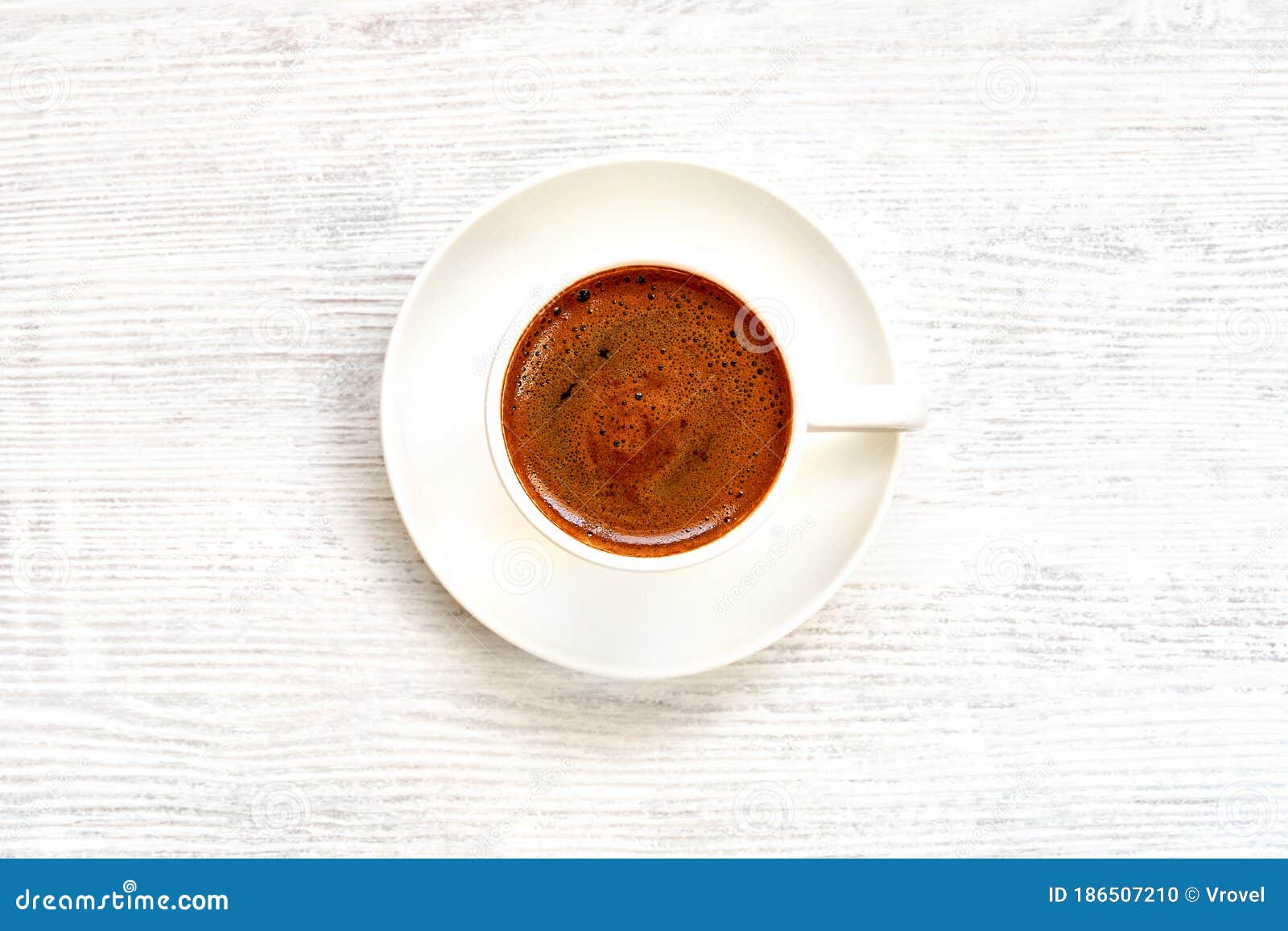coffee cup with turkish coffee on white wooden table . top view