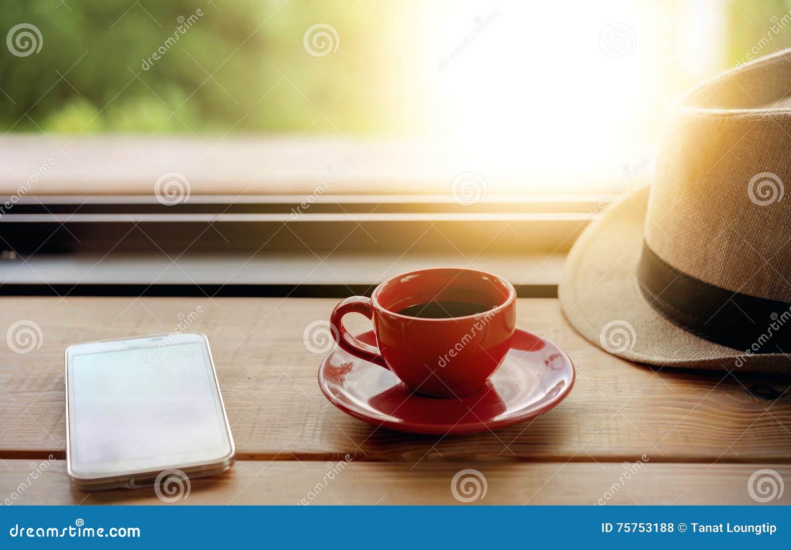 Coffee with Hat and Smart Phone on Coffee Shop Table Stock Photo