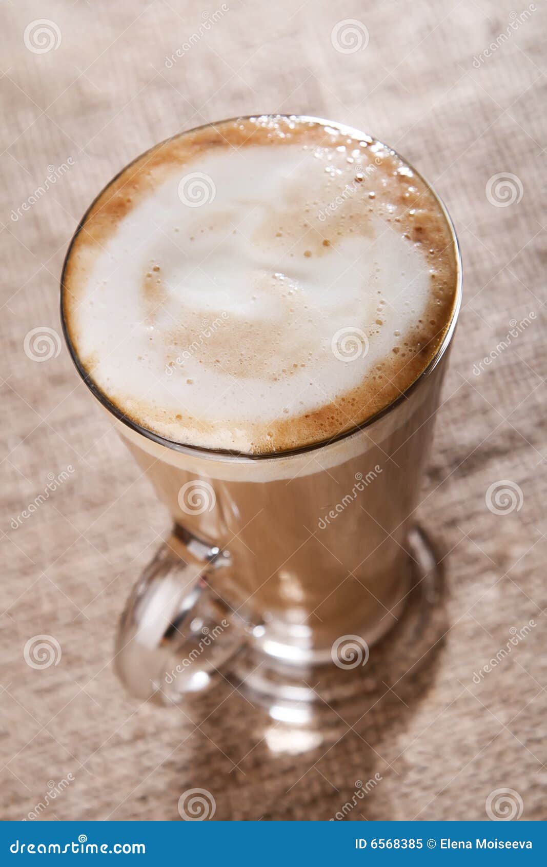 coffee latte with closeup froth on rustic