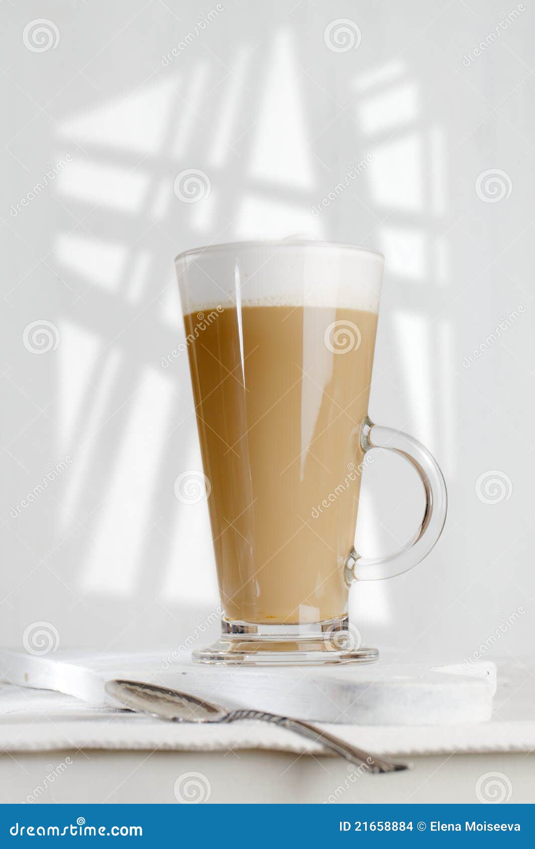 coffee latte with frothy milk in tall glass