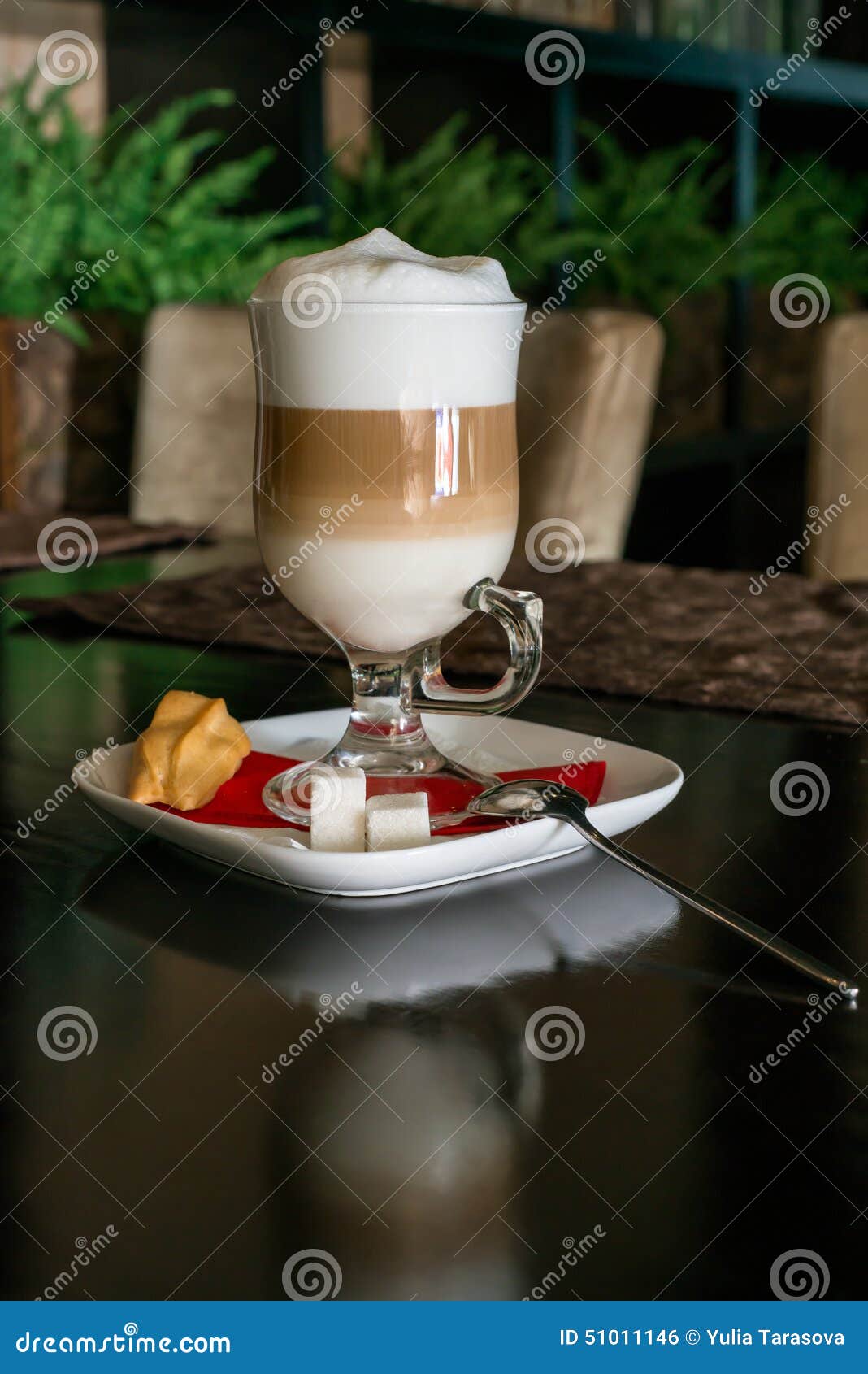 coffee latte in transparent glass silver in cafe, latte macchiato