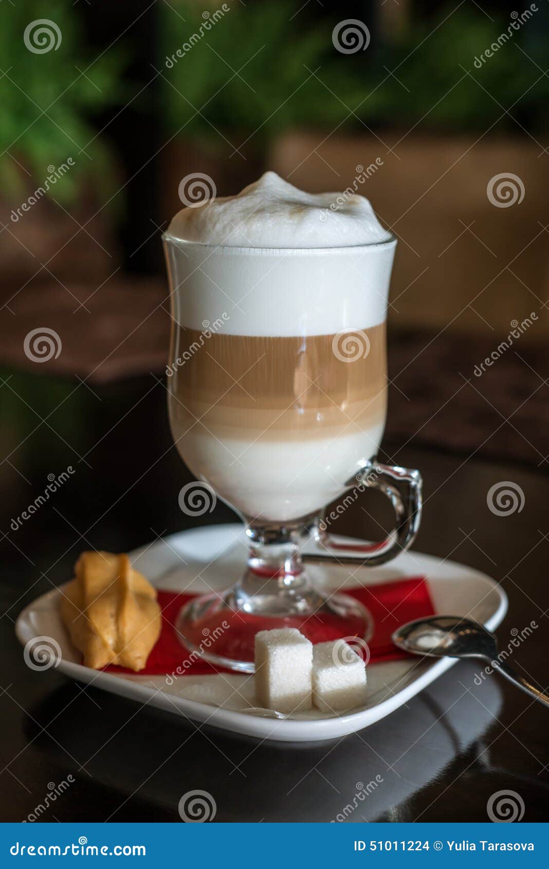 coffee latte in transparent glass silver in cafe, latte macchiato