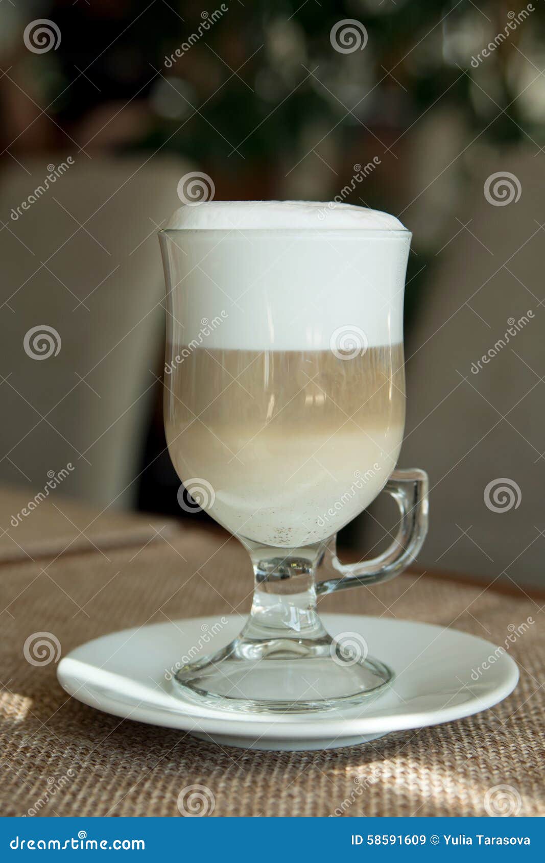 coffee latte in transparent glass silver in cafe, latte macchiat