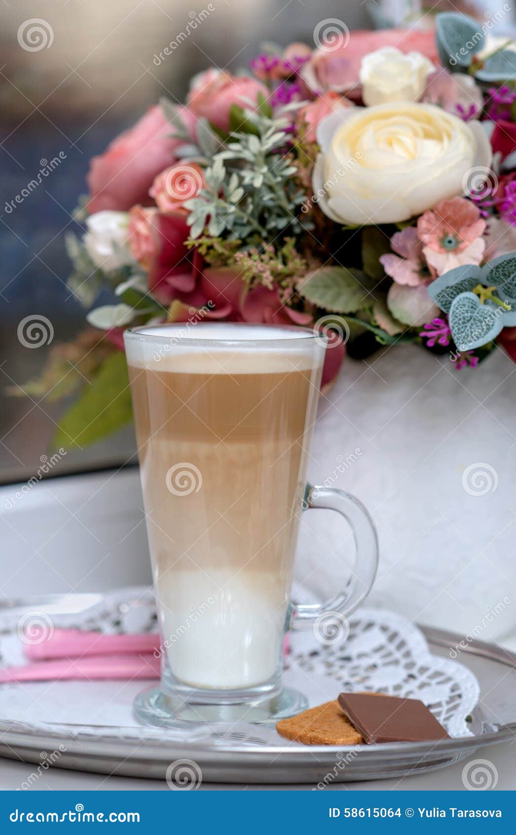 coffee latte in transparent glass silver in cafe, latte macchiat