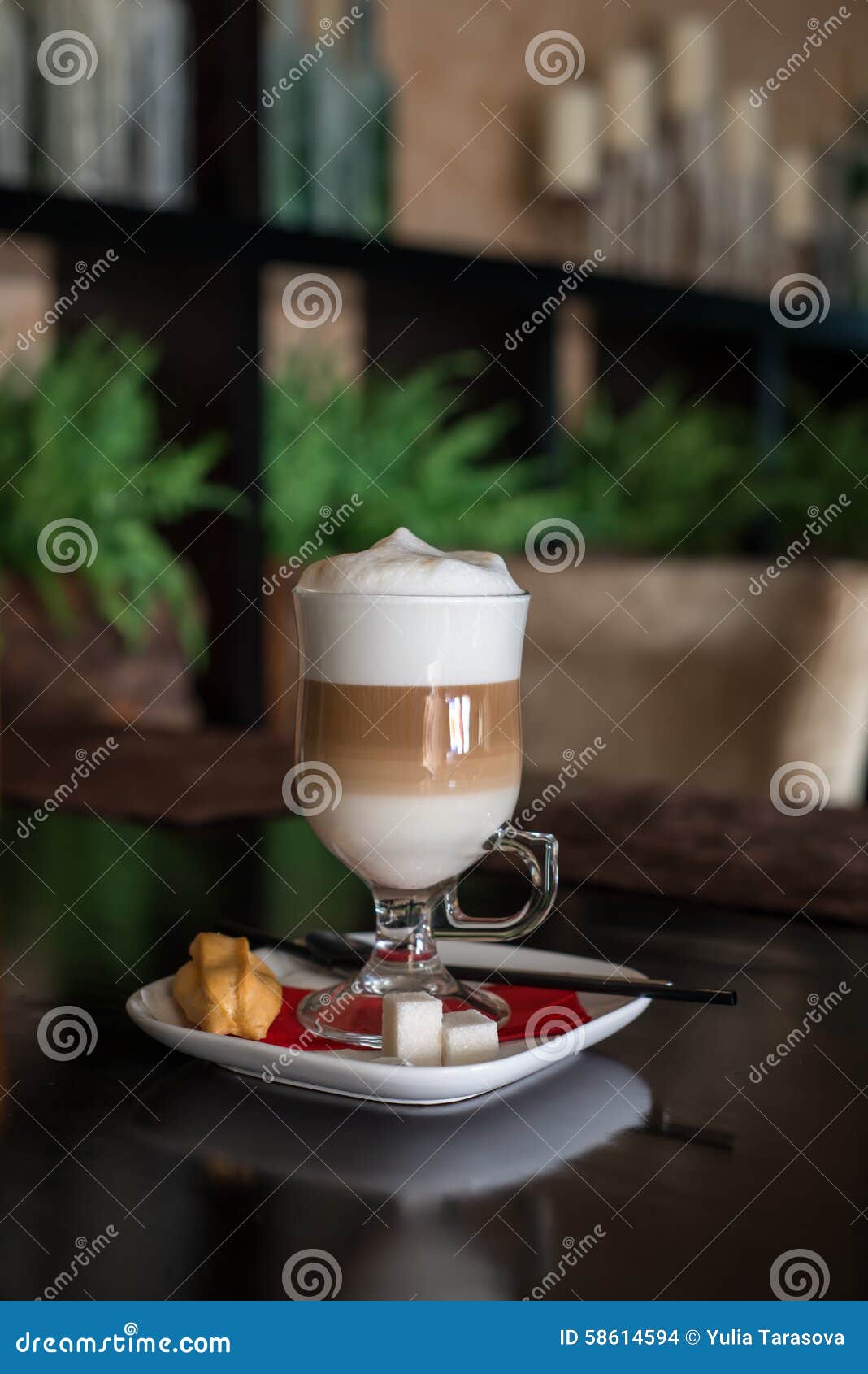 coffee latte in transparent glass silver in cafe