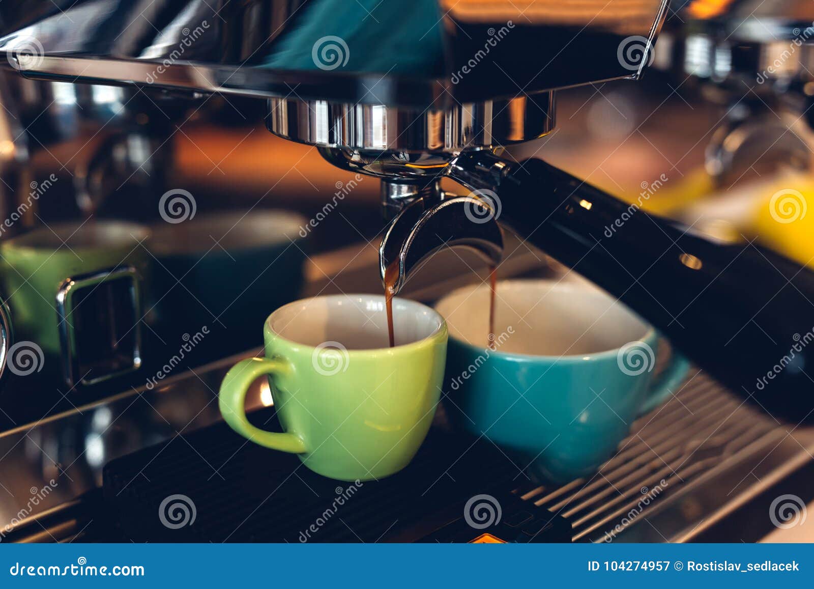coffee machine preparing espresso and pouring into colored cups