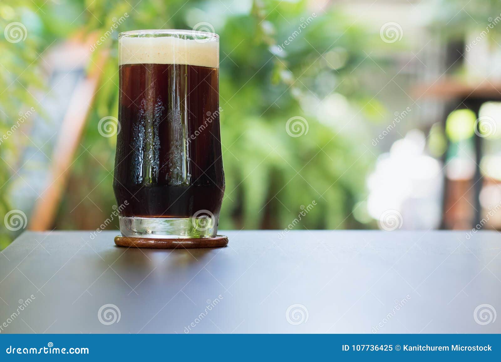 coffee nitro cold brew in glass on table outdoor cafe