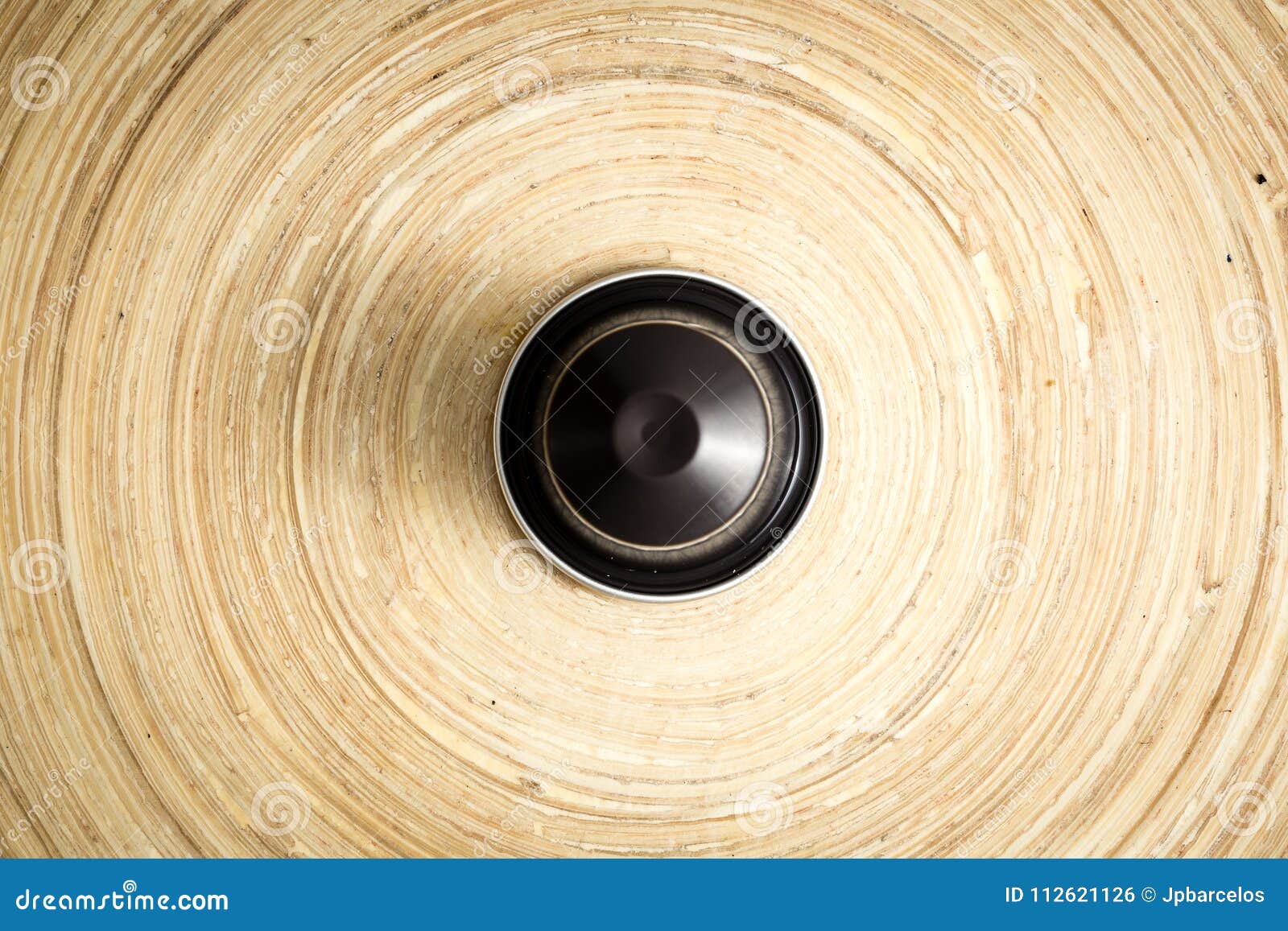 coffee pod on bamboo surface, hero shot, soft light, focused lighting