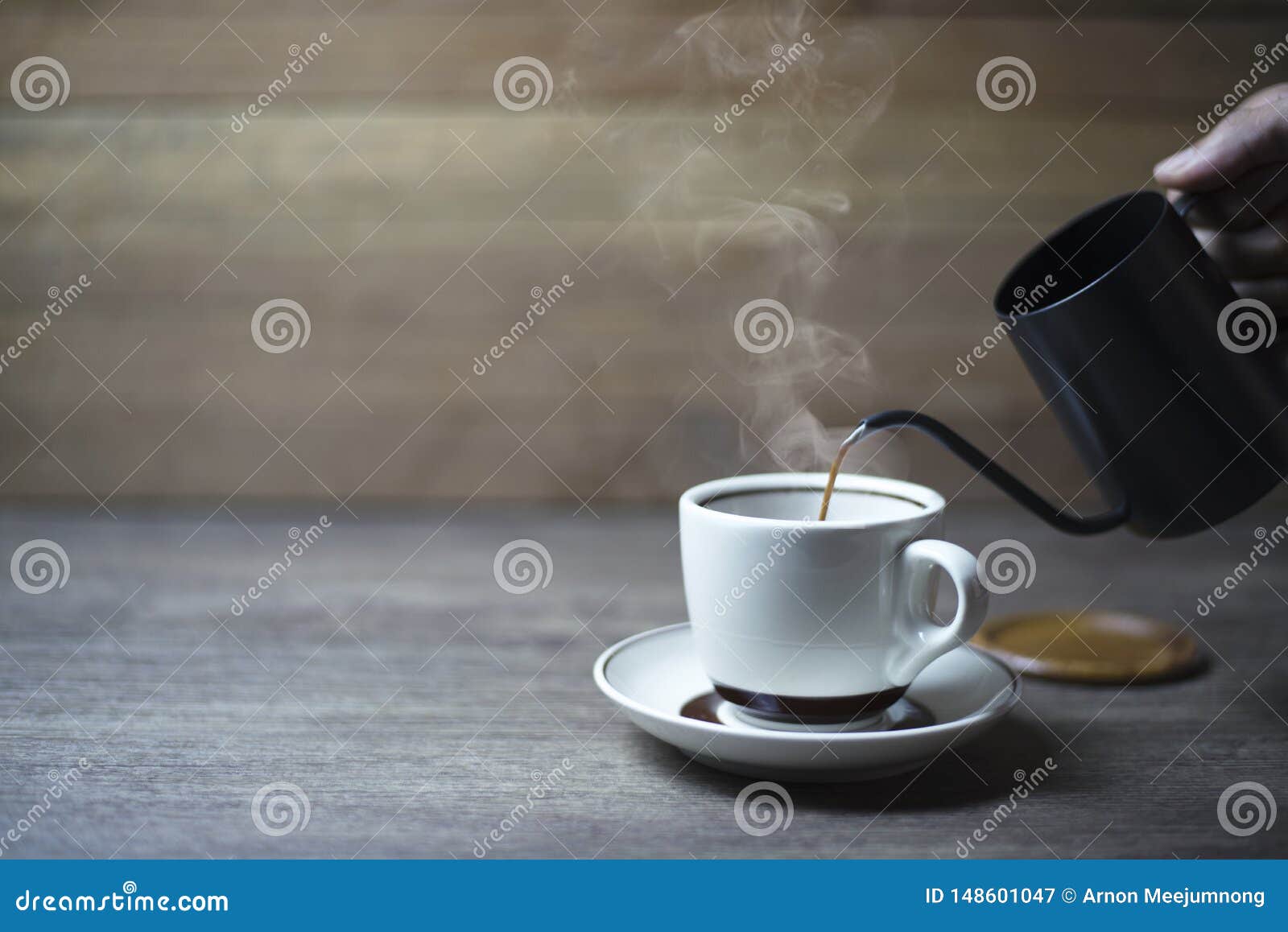 Coffee Time, Black Coffee in a Kettle that is Pouring into the Cup