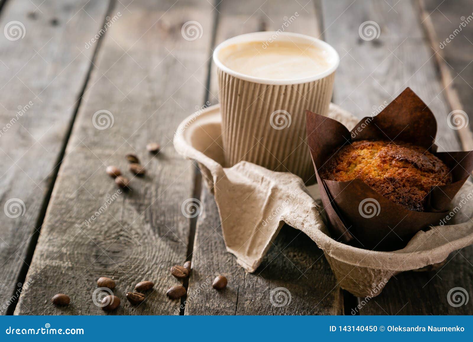 coffee to go with muffin on wood background