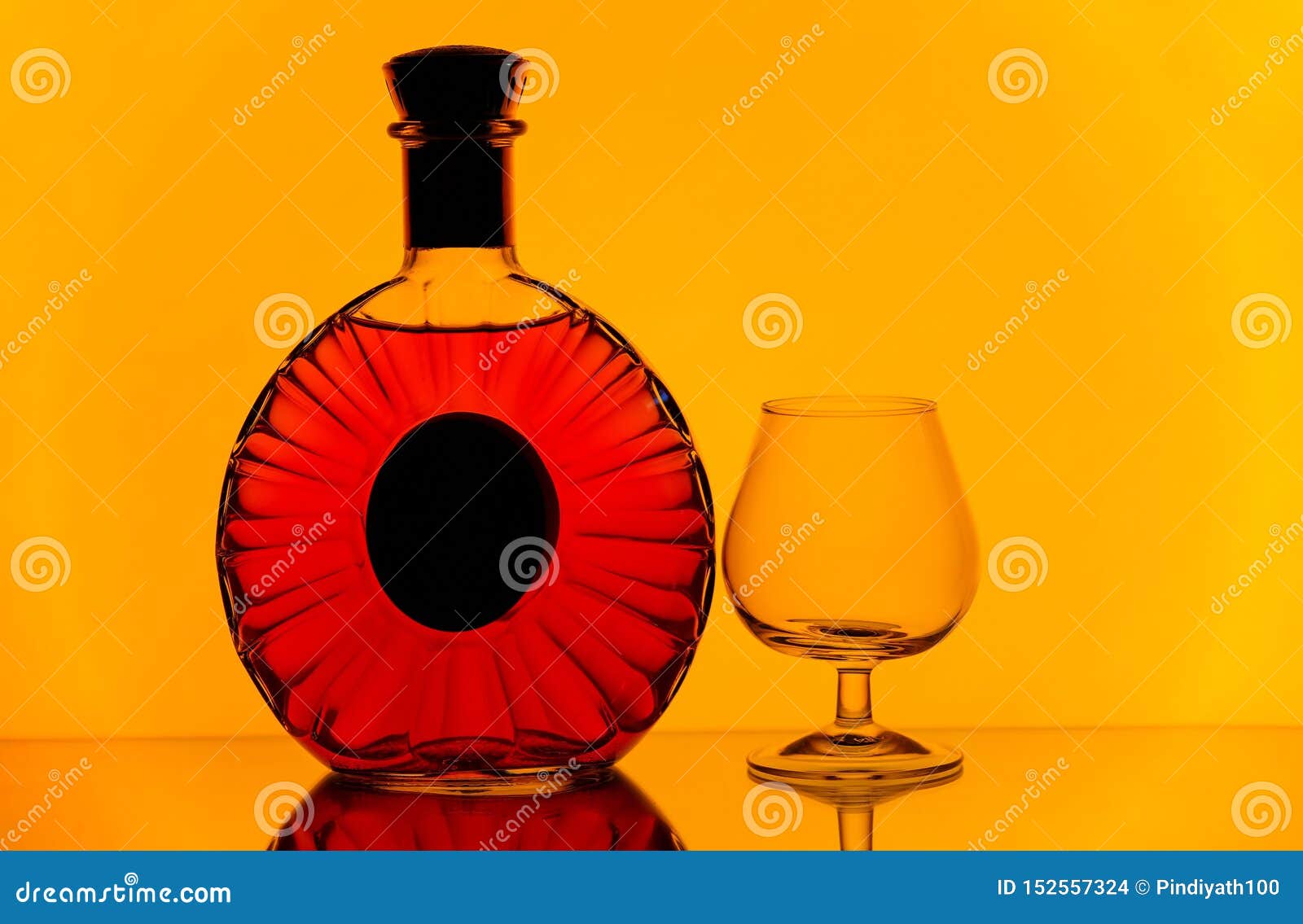 Download Cognac Bottle And Snifter Glass Against Golden Yellow Background Stock Photo Image Of Alcohol Silhouettes 152557324 Yellowimages Mockups