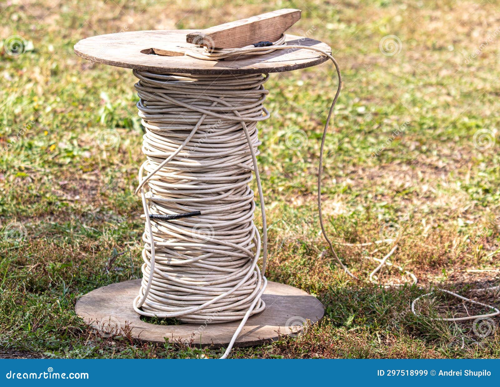 A Coil of Electrical Wire Stands on the Ground in the Park Stock Image