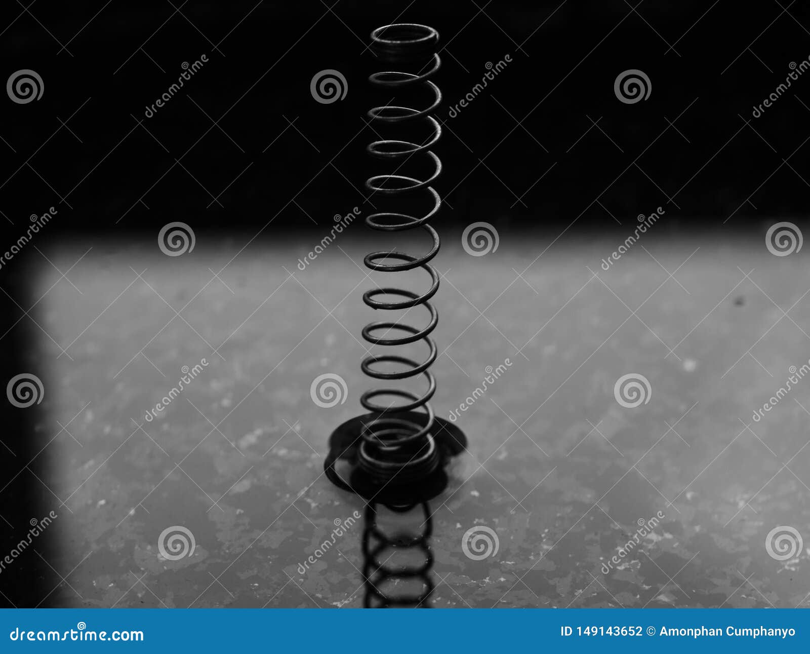 A Coil Spring from a Ballpoint Pen on Abstract Background Stock Photo