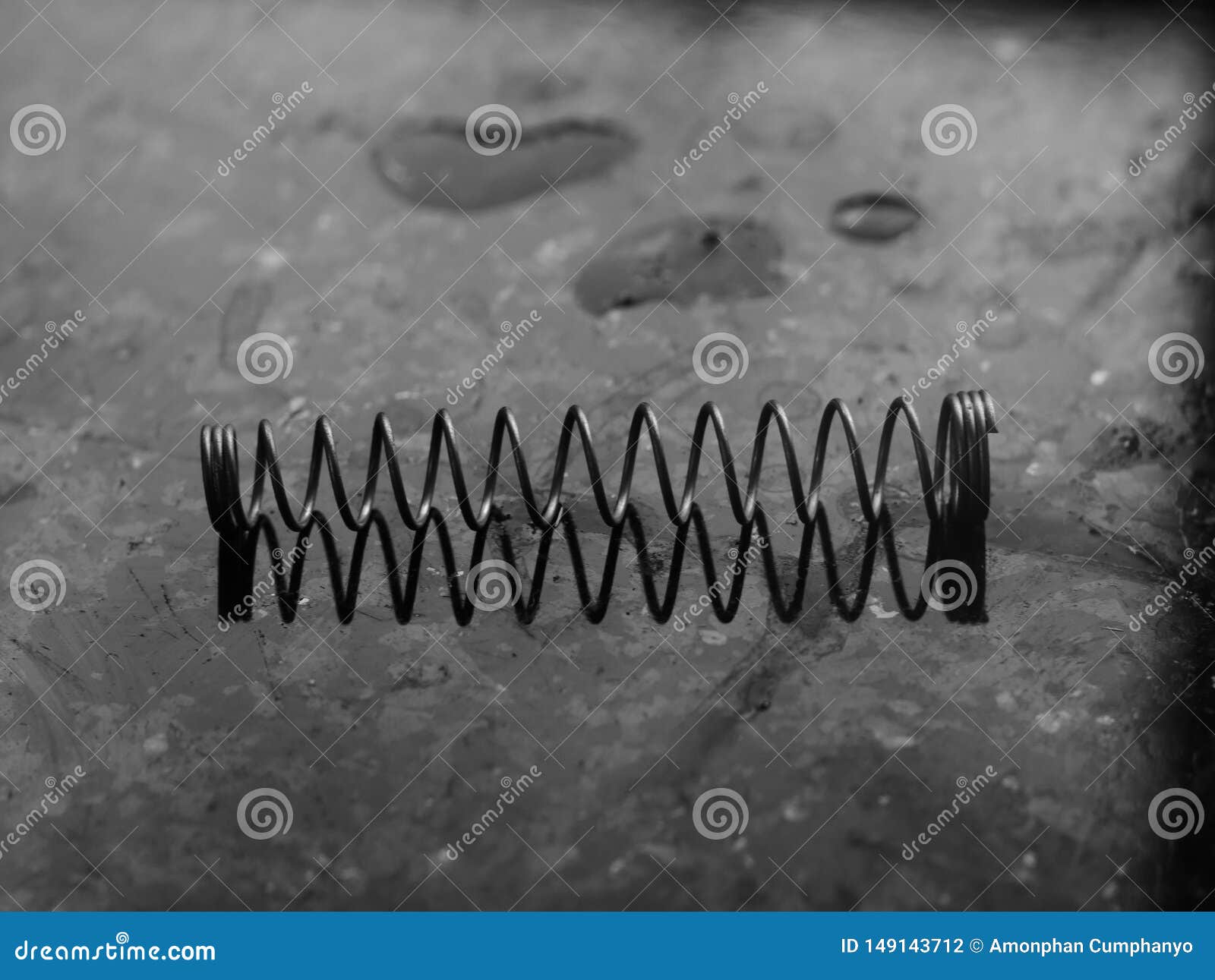 A Coil Spring from a Ballpoint Pen on Abstract Background Stock Photo