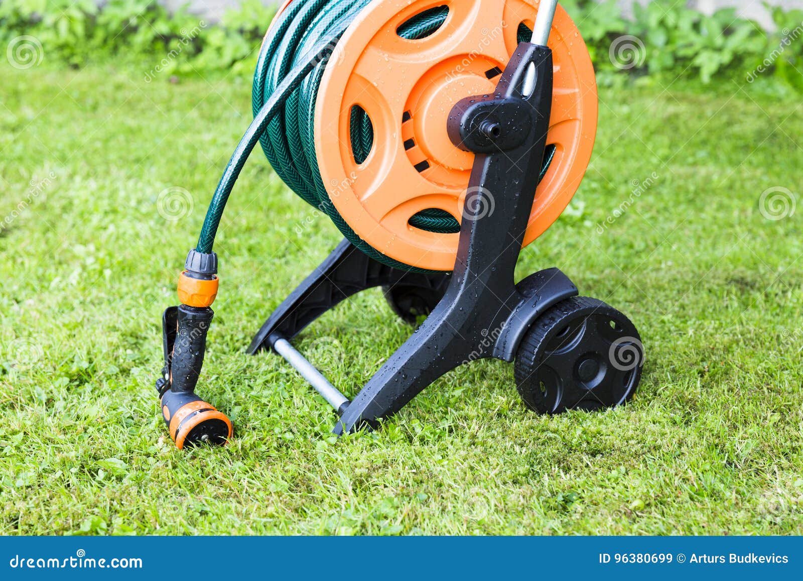 Coiled garden hose on reel stock image. Image of color 96380699