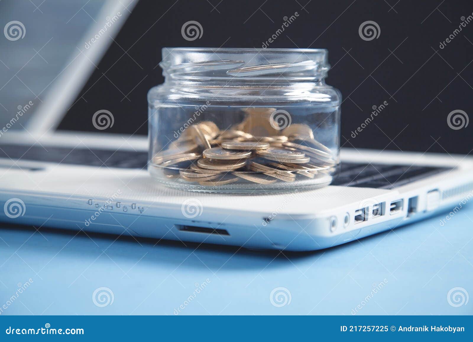 Magnifying glass and coins on the white desk.