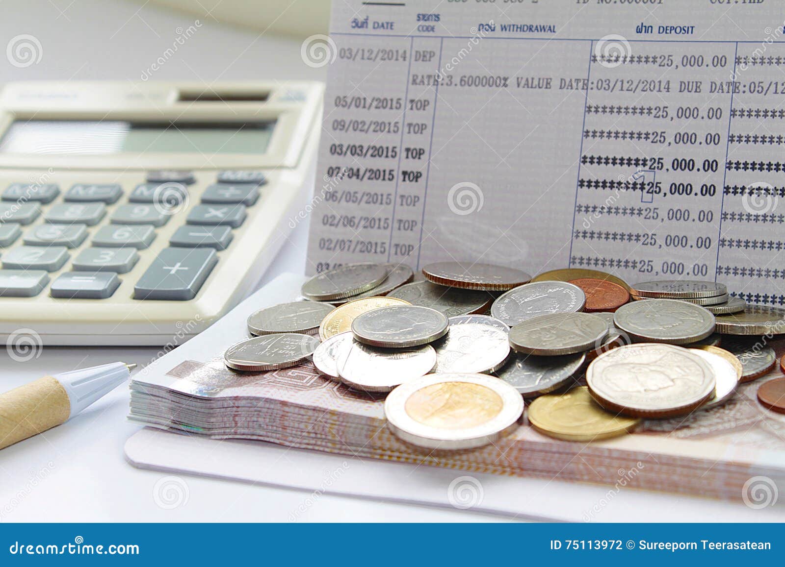 Coins, Pen and Calculator on Savings Account Passbook Stock Photo