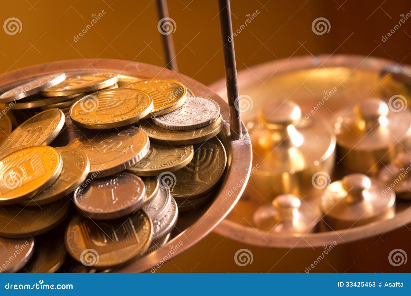 Businessman Covering Stacked Coins On Golden Weighing Scale At Wooden Table  Stock Photo, Picture and Royalty Free Image. Image 84268953.