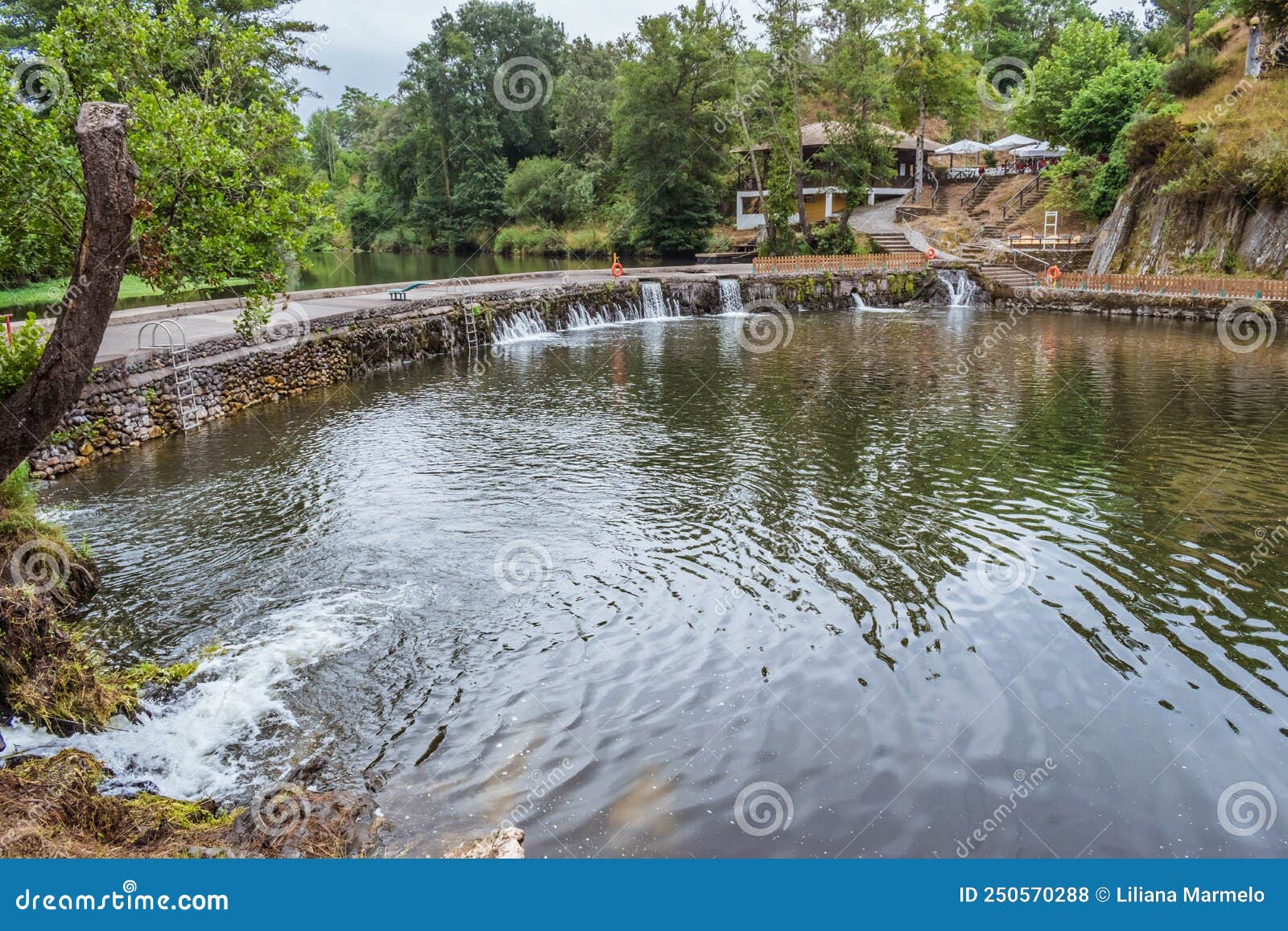 coja river beach with stone weir and small waterfalls of the river alva, arganil portugal