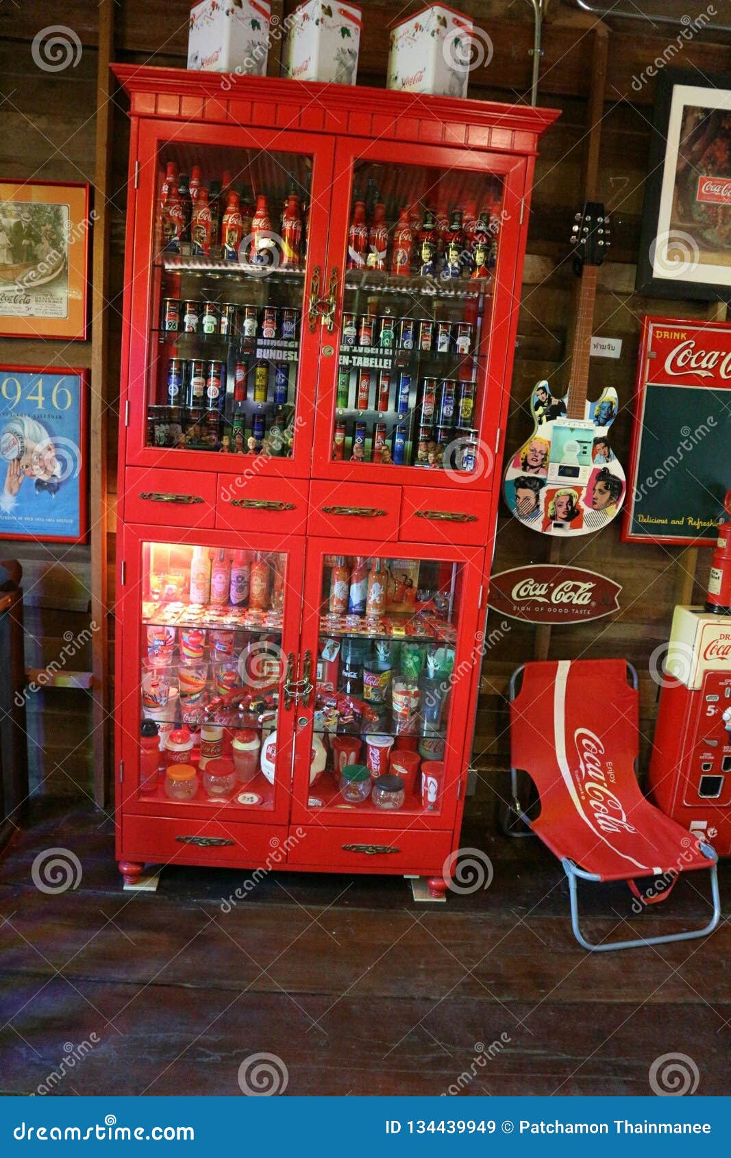 Coke In A Beautiful Red Cabinet Is Located On A Wooden Floor