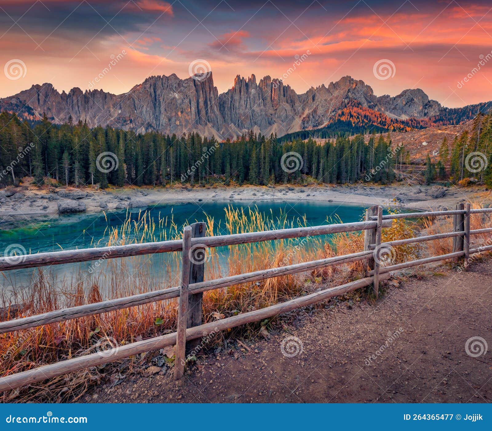 cold autumn morning on karersee lake, province of bolzano - south tyrol.