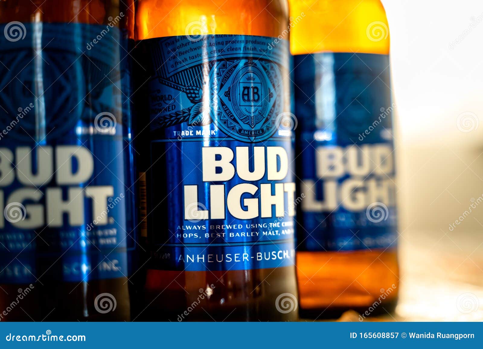 Cold Bottles of Bud Light Beer with Drops Over Green Background