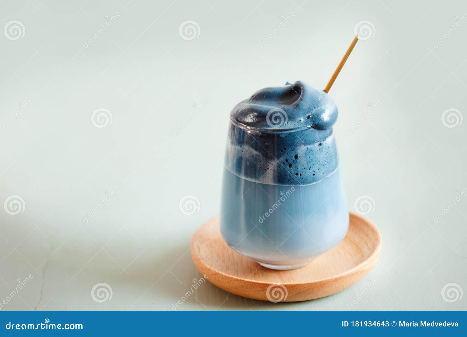Cold Latte with Blue Spirulina, Healthy Drink on Blue Background Stock