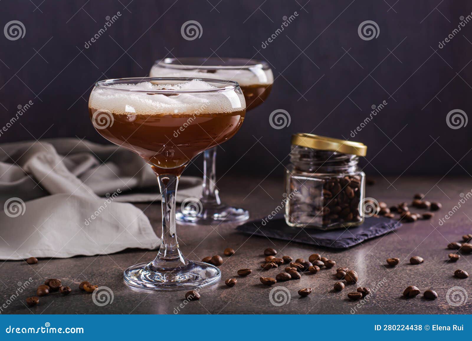 Cold Martini Espresso Cocktail in Glasses and Coffee Beans on the Table