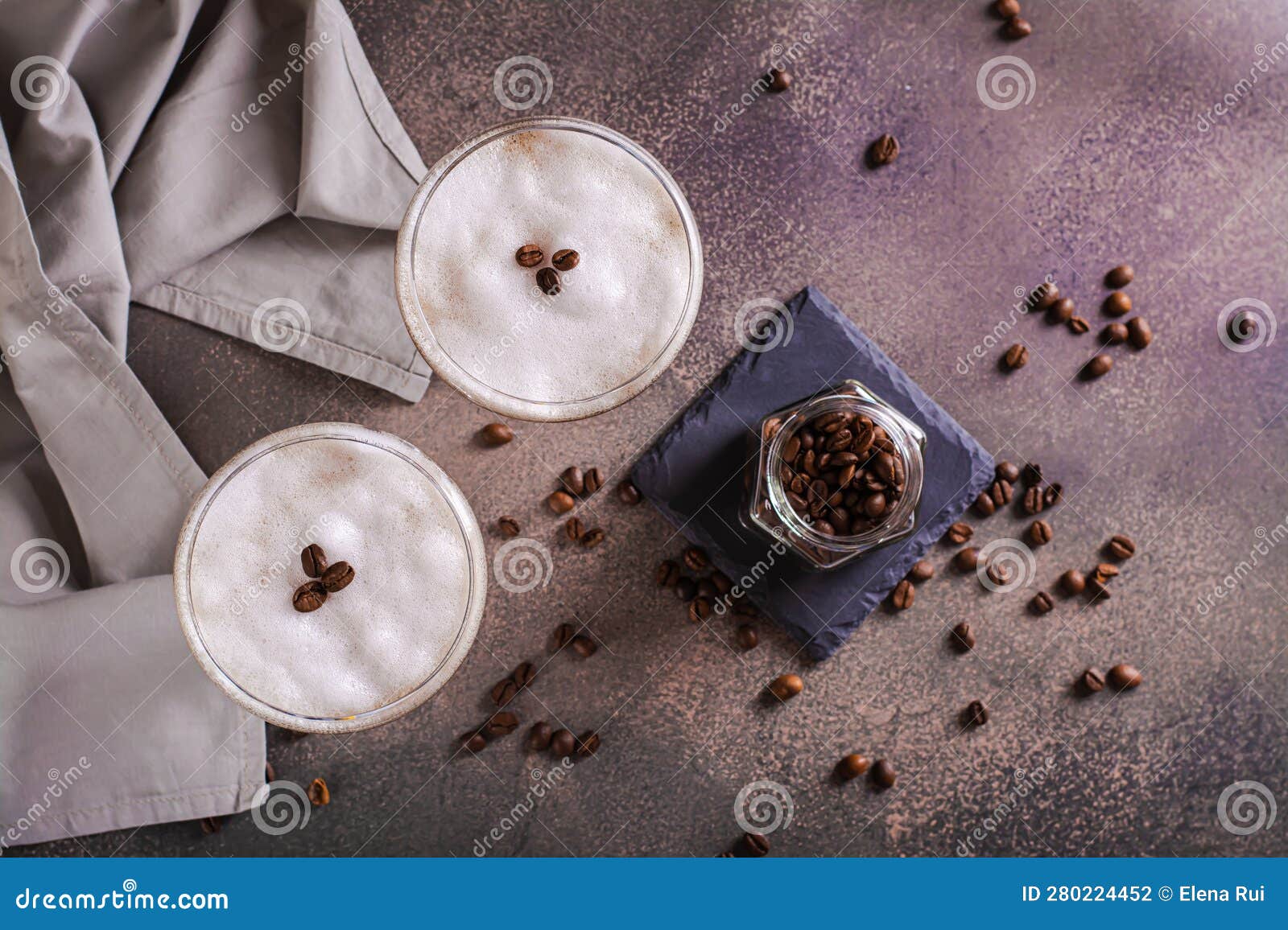 Cold Martini Espresso Cocktail in Glasses and Coffee Beans on the Table