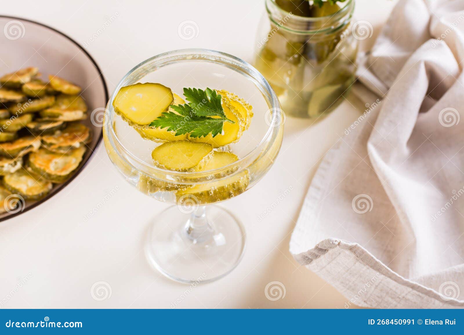 Cold Pickleback Cocktail with Pickles and Parsley in Glasses on the