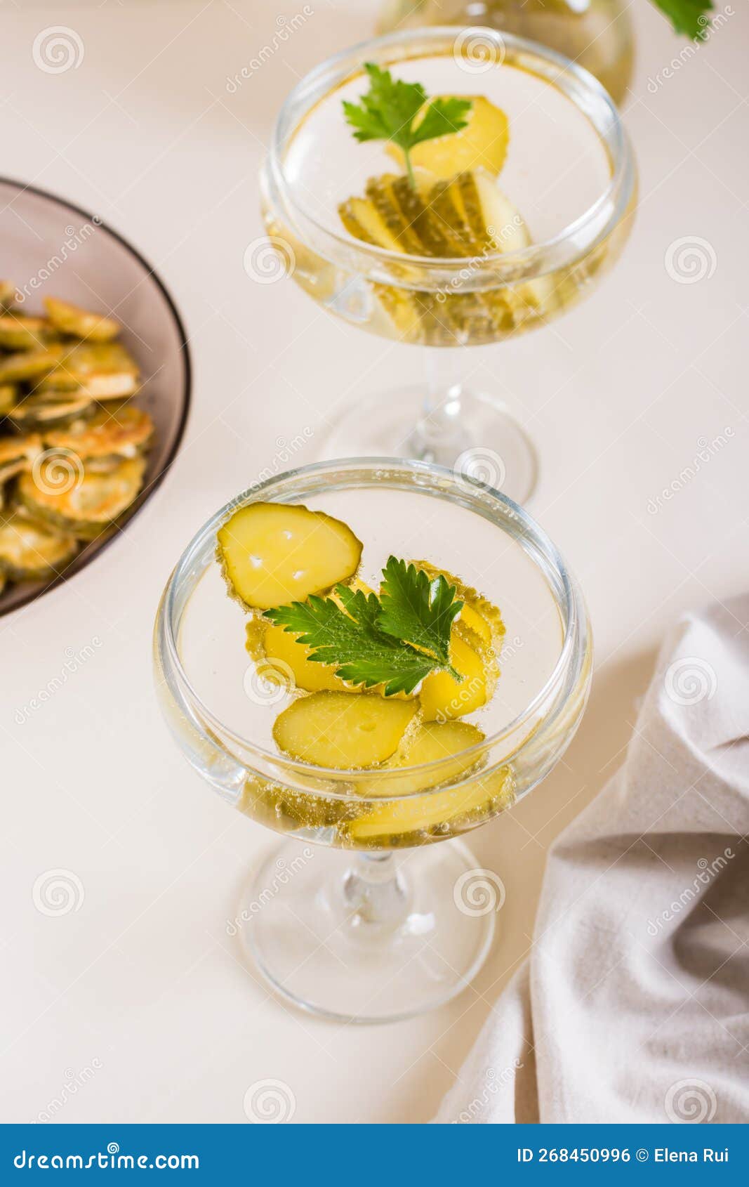 Cold Pickleback Cocktail with Pickles and Parsley in Glasses on the