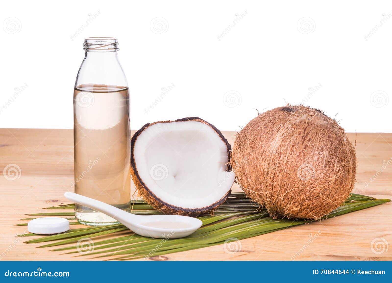 Cold Pressed Extra Virgin Coconut Oil In Bottles With Coconuts Stock