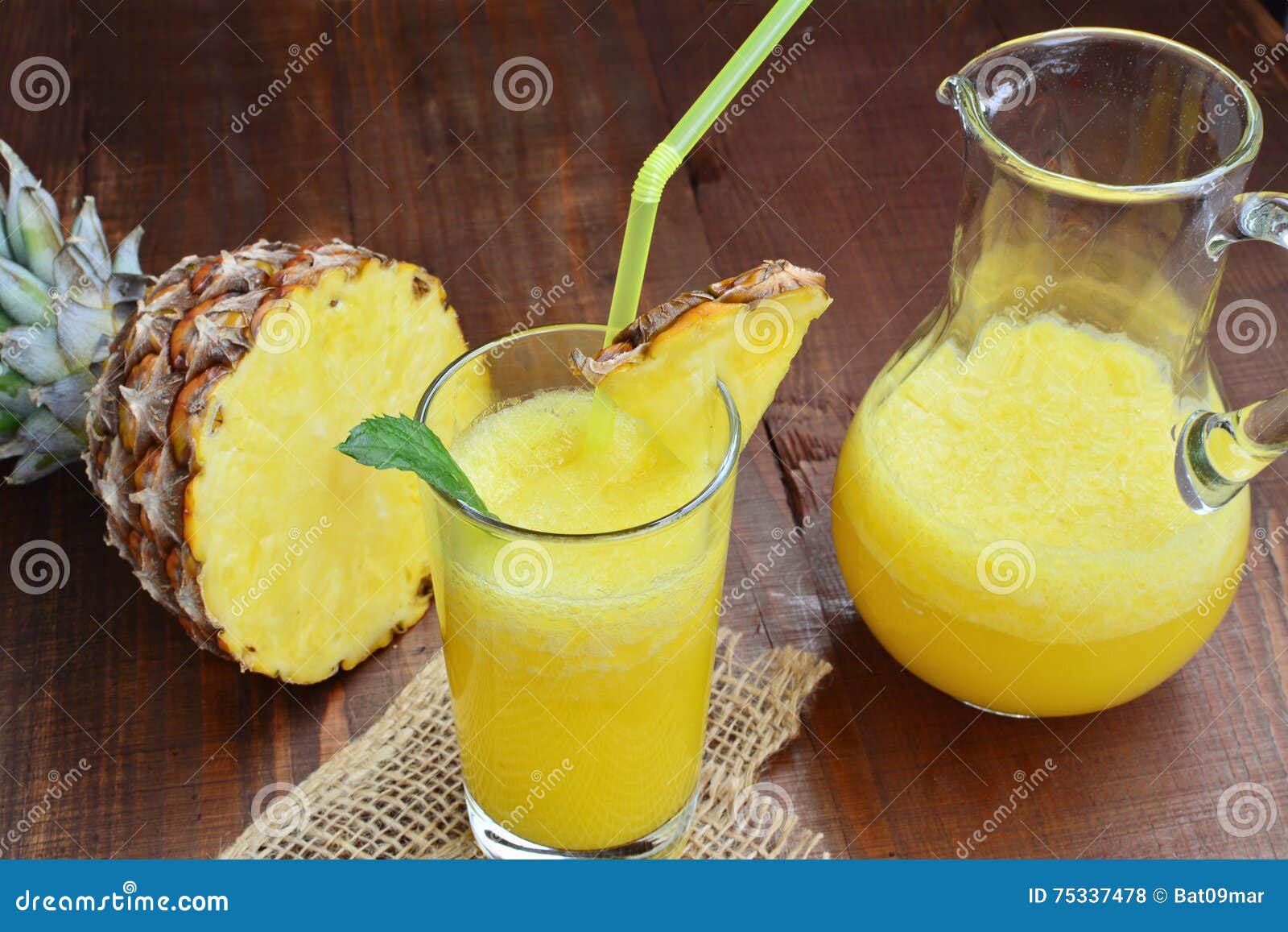 Cold Refreshing Pineapple Mocktail Drink in Glass and Pitcher Stock