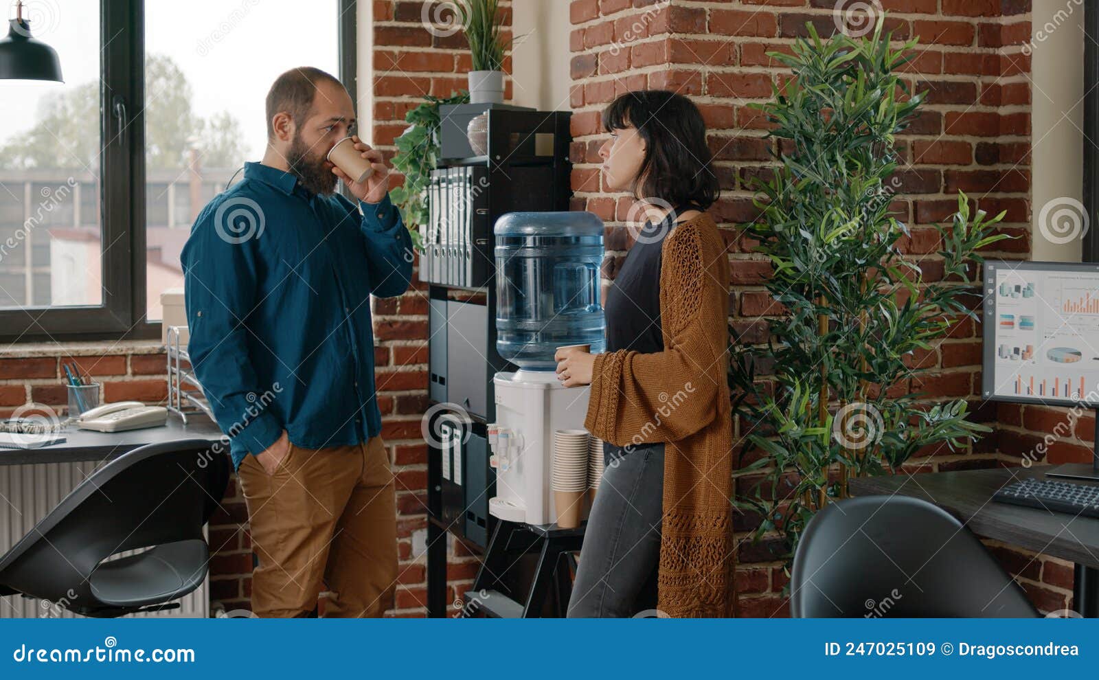 Colleagues on Break Having Discussion and Using Water Cooler Stock