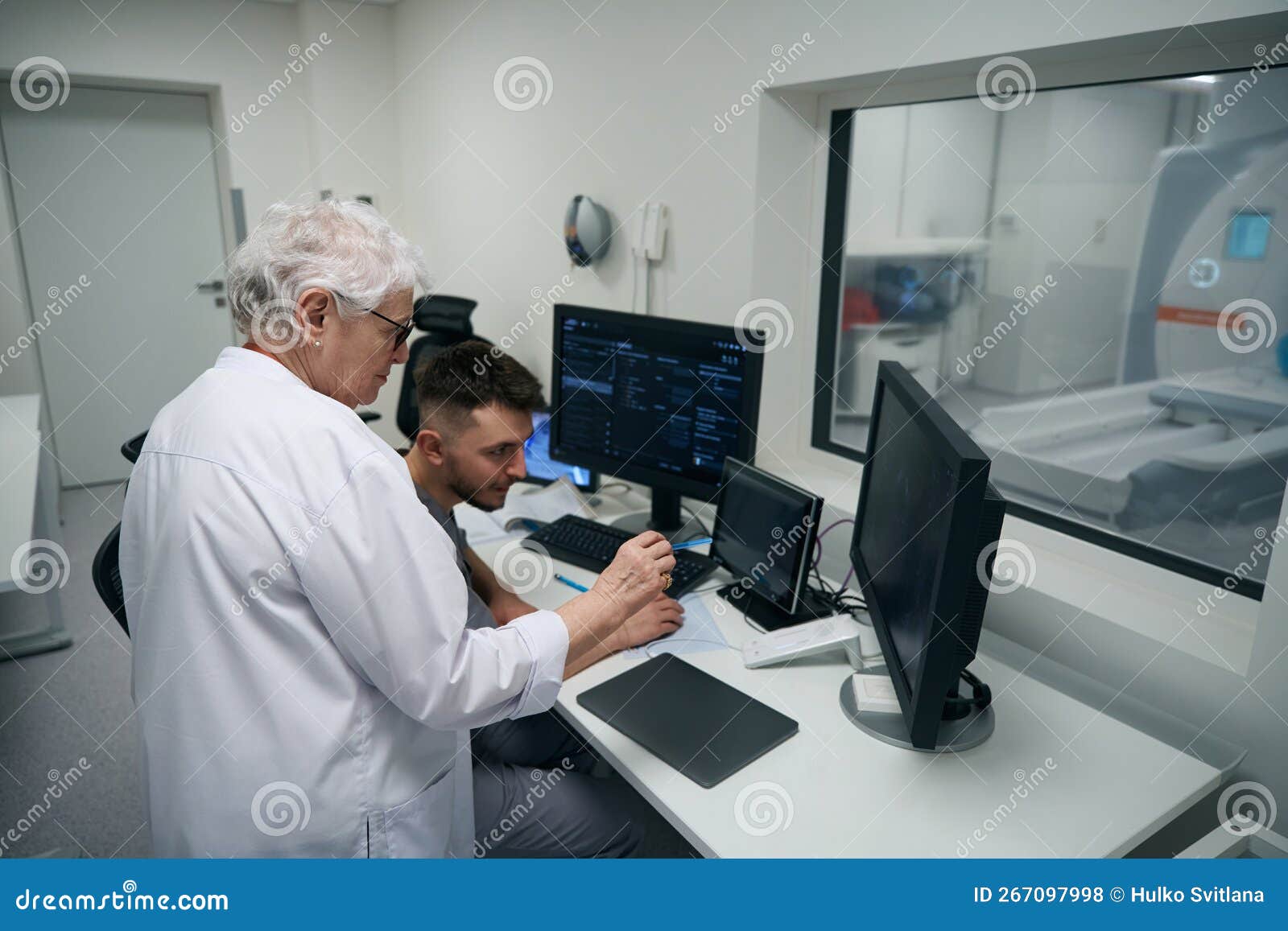 Colleagues Diagnosticians Perform MRI of the Brain Stock Photo Image