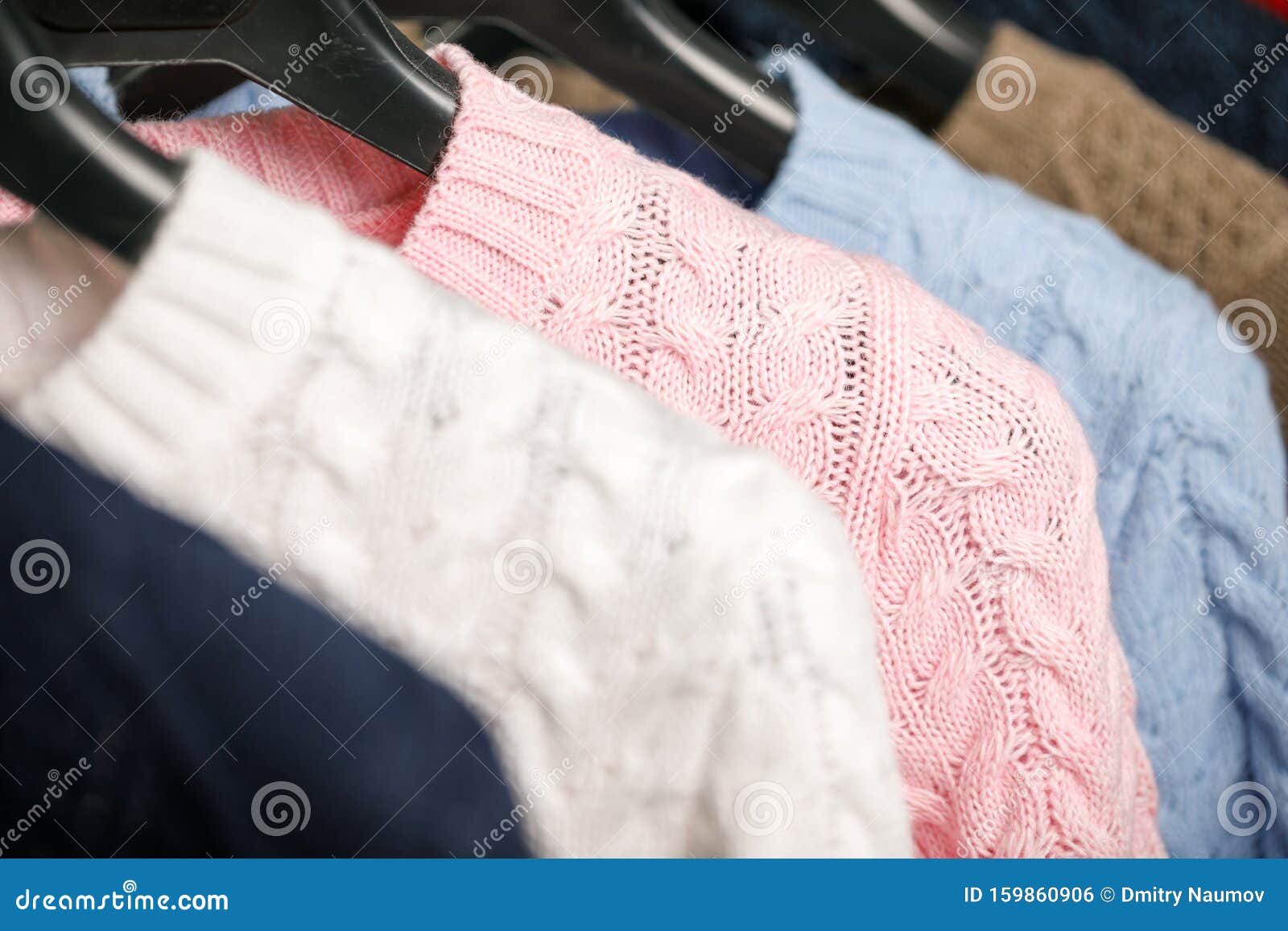 Collection of Cable Knit Sweaters on Hanger Rack in a Store for Sale