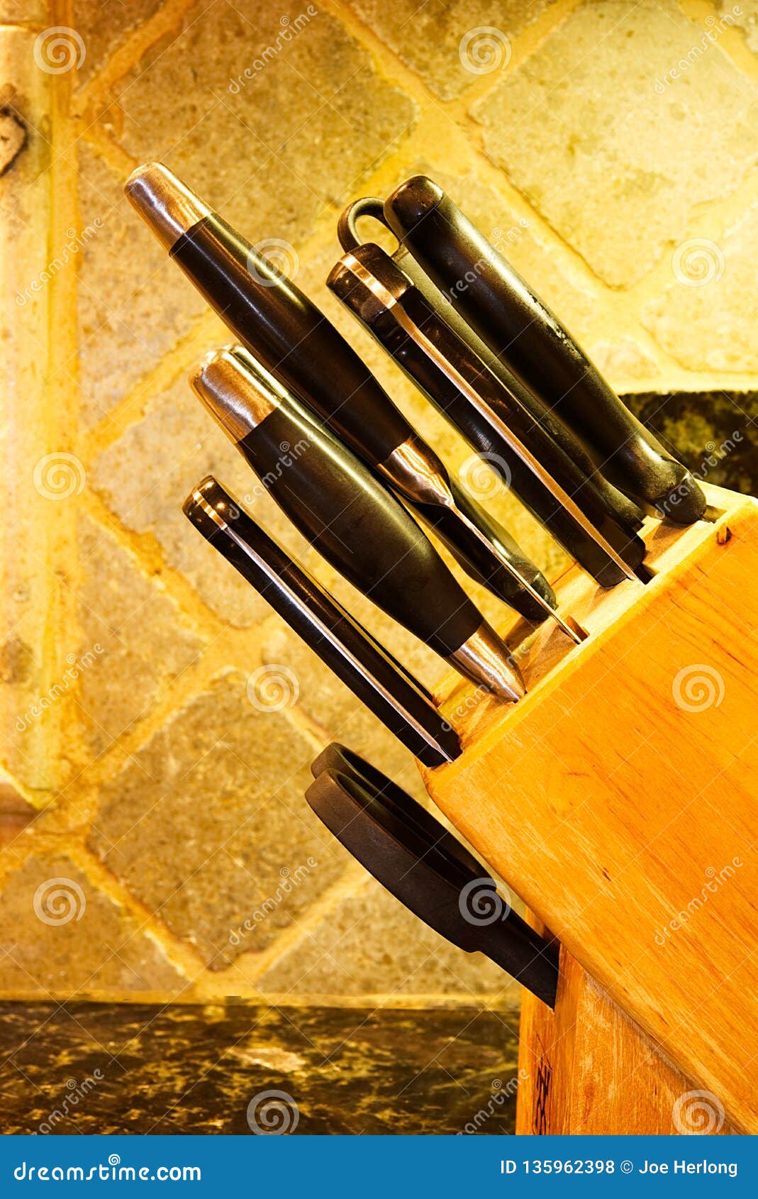 Closeup Of A Wooden Block Full Of Kitchen Knives On A Granite