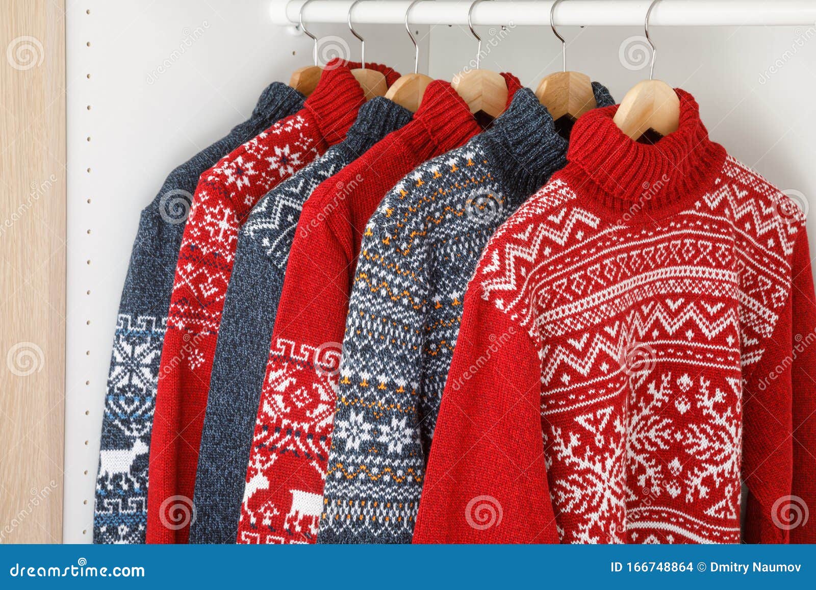 Collection of Knitted Christmas Turtleneck Sweaters on Hanger Rack in a ...