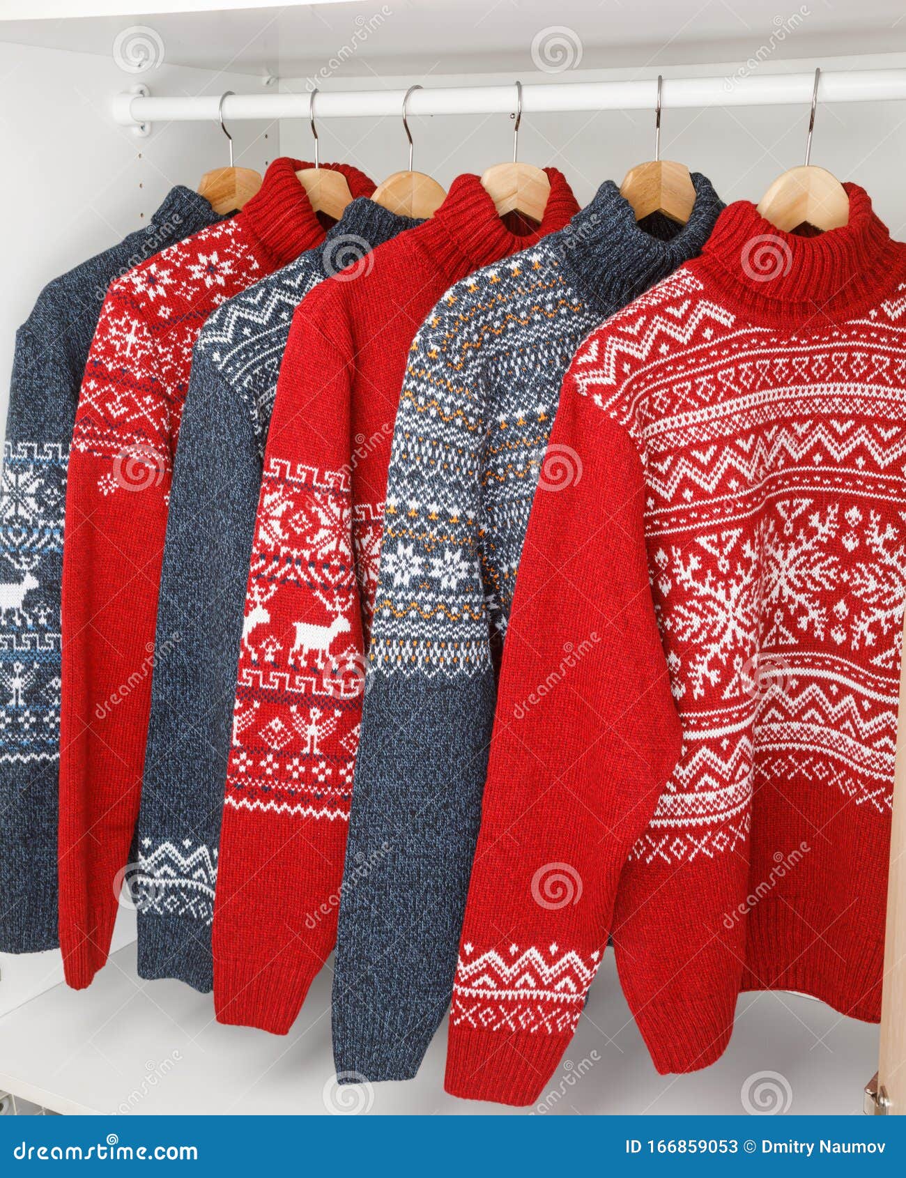 Collection of Knitted Christmas Turtleneck Sweaters on Hanger Rack in a ...