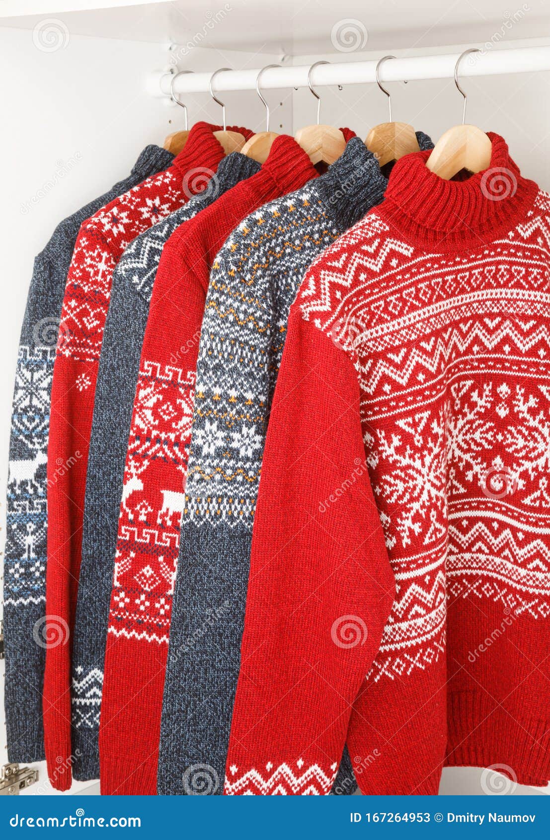 Collection of Knitted Christmas Turtleneck Sweaters on Hanger Rack in a ...