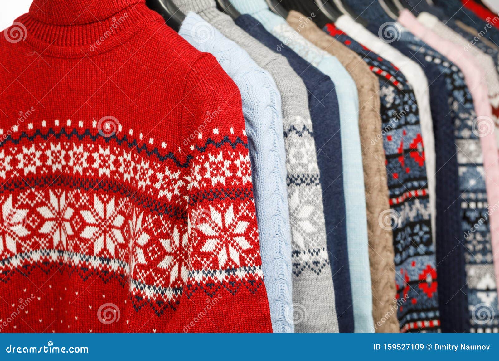 Collection of Knitted Sweaters on Hanger Rack in a Store or at a ...